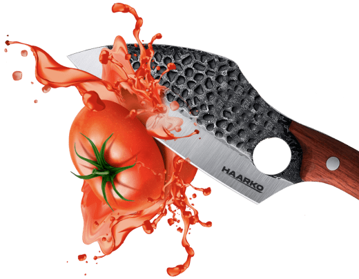 Knife slicing tomato